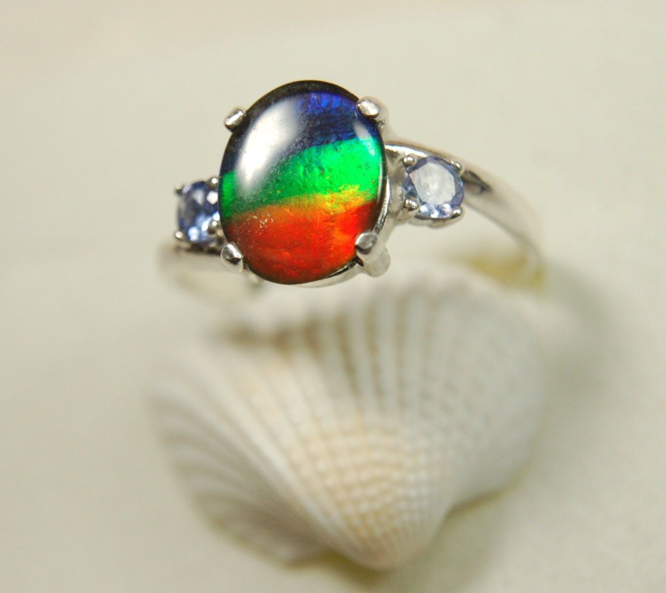 Ammolite Ring with brilliant colors and Tanzanite side stones.Size 7 #120223