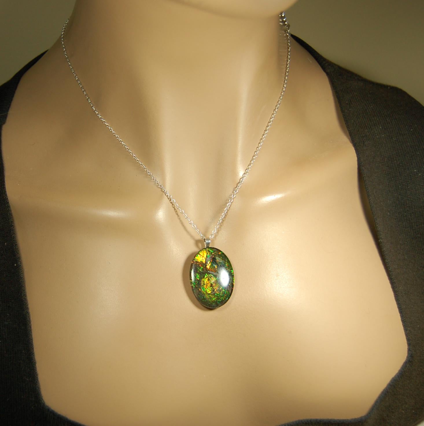 Ammolite cabochon pendant to upgrade your fashion accessory collection.Green and Copper colors.Sterling silver bail.Birthday gift? 032716