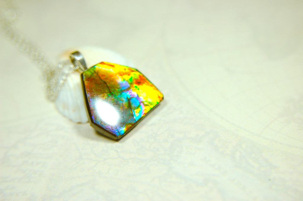 Ammolite pendant.RARE colors.Best seen in video.All natural cabochon from Alberta Canada.Thoughtful gift for her.022716