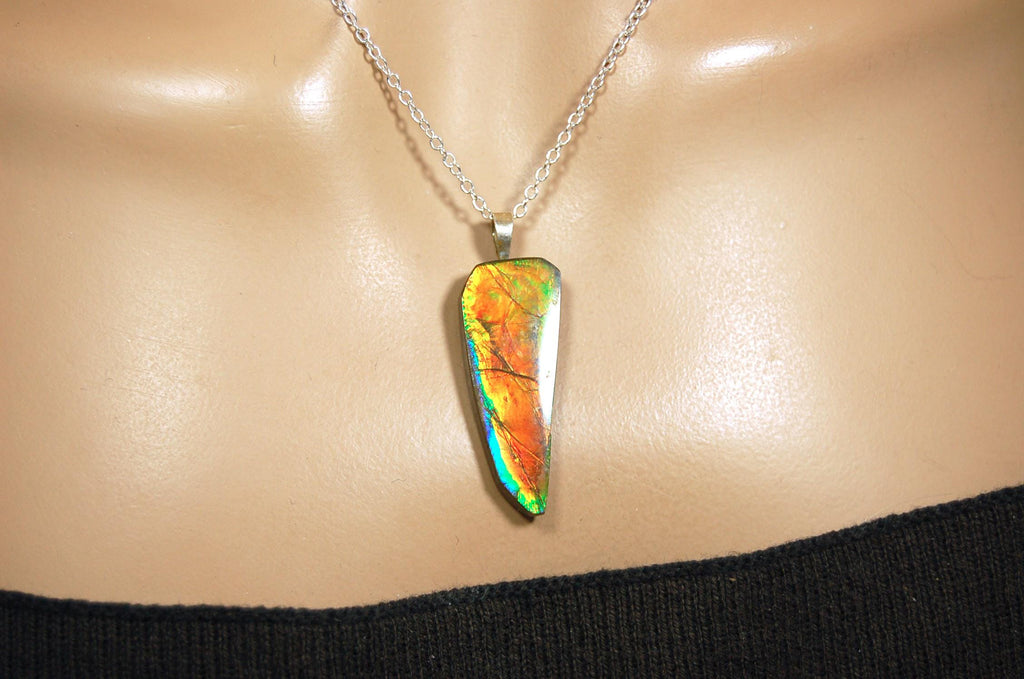 Ammolite necklace pendant.Natural rainbow cabochon of many bright colors.Strong color shifter.Video shows color best.030116