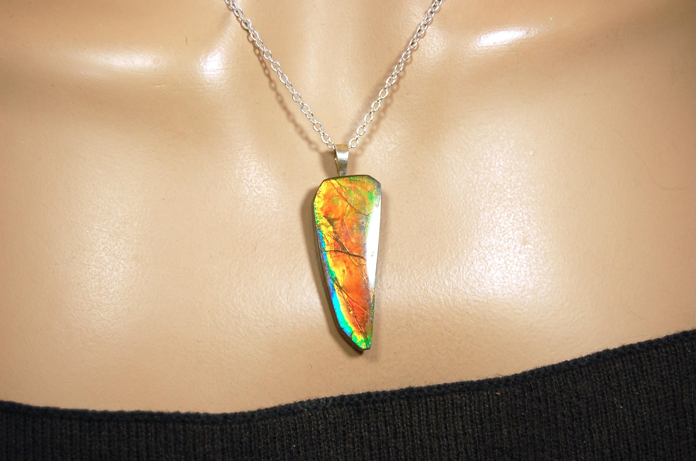 Ammolite necklace pendant.Natural rainbow cabochon of many bright colors.Strong color shifter.Video shows color best.030116