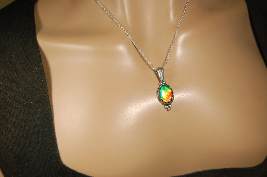 Ammolite Pendant elegantly set in sterling silver.Lovely greens and blues and flash of red.Fine anniversary gift idea for  wife.041916