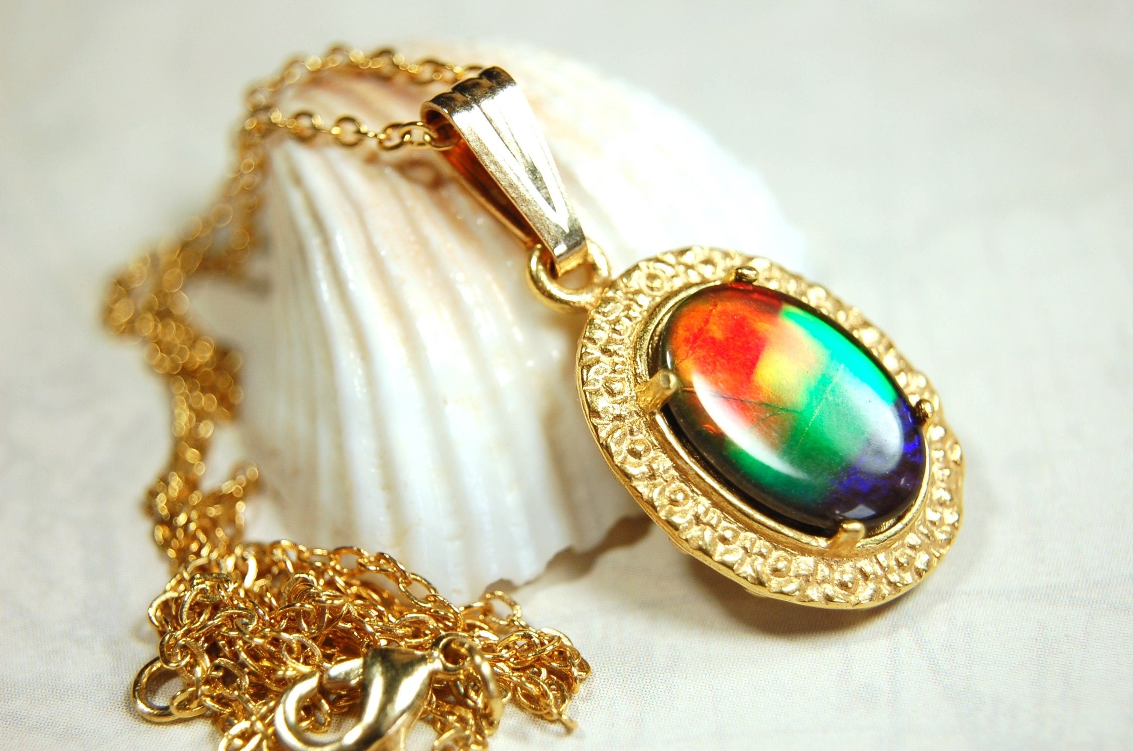 Genuine rainbow Ammolite pendant in 14k gold fill setting.#070414