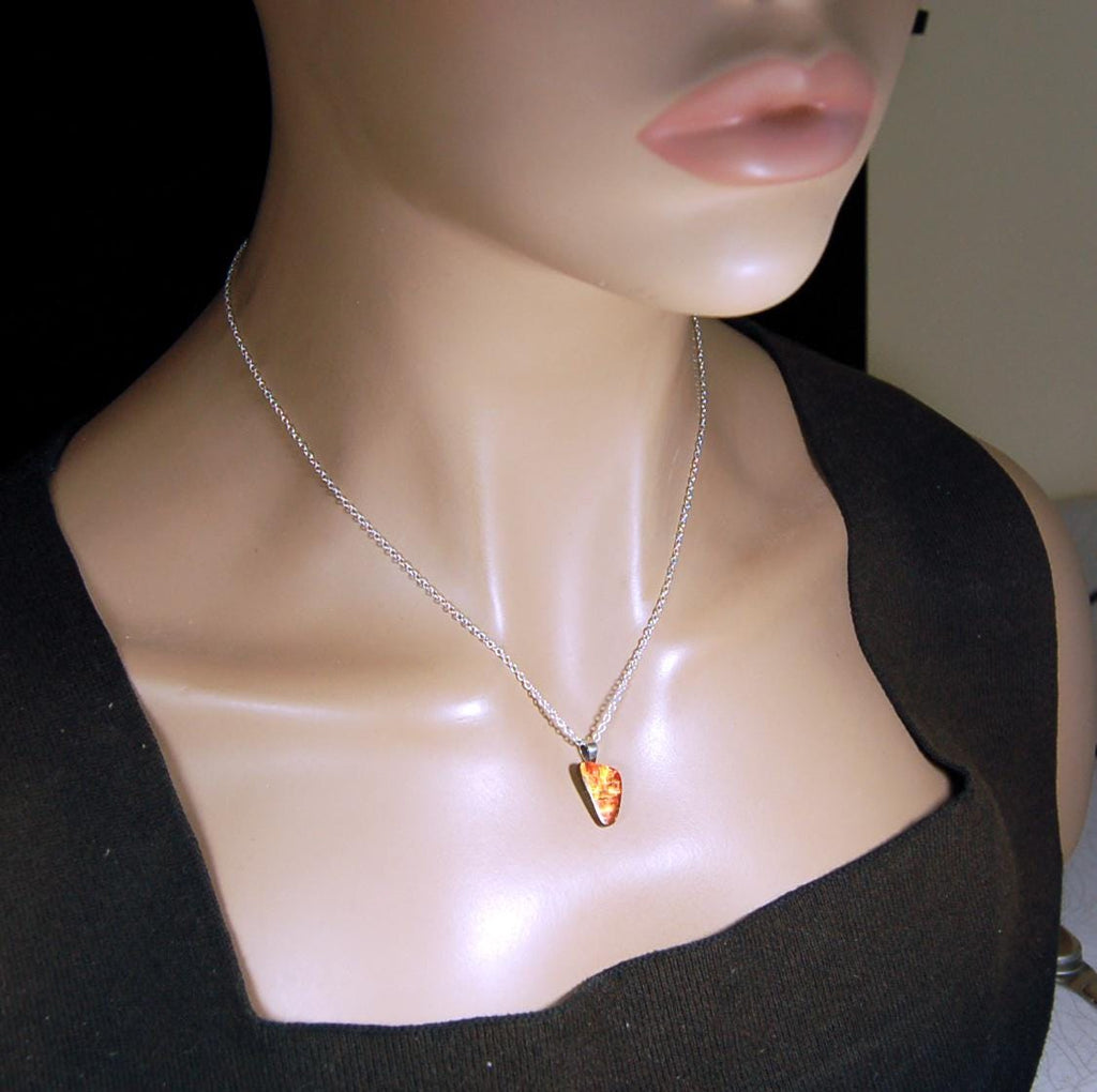 Ammolite Pendant with a gem of fire best appreciated in video.Amazing brilliance and hot colors.A big attention getter.022416