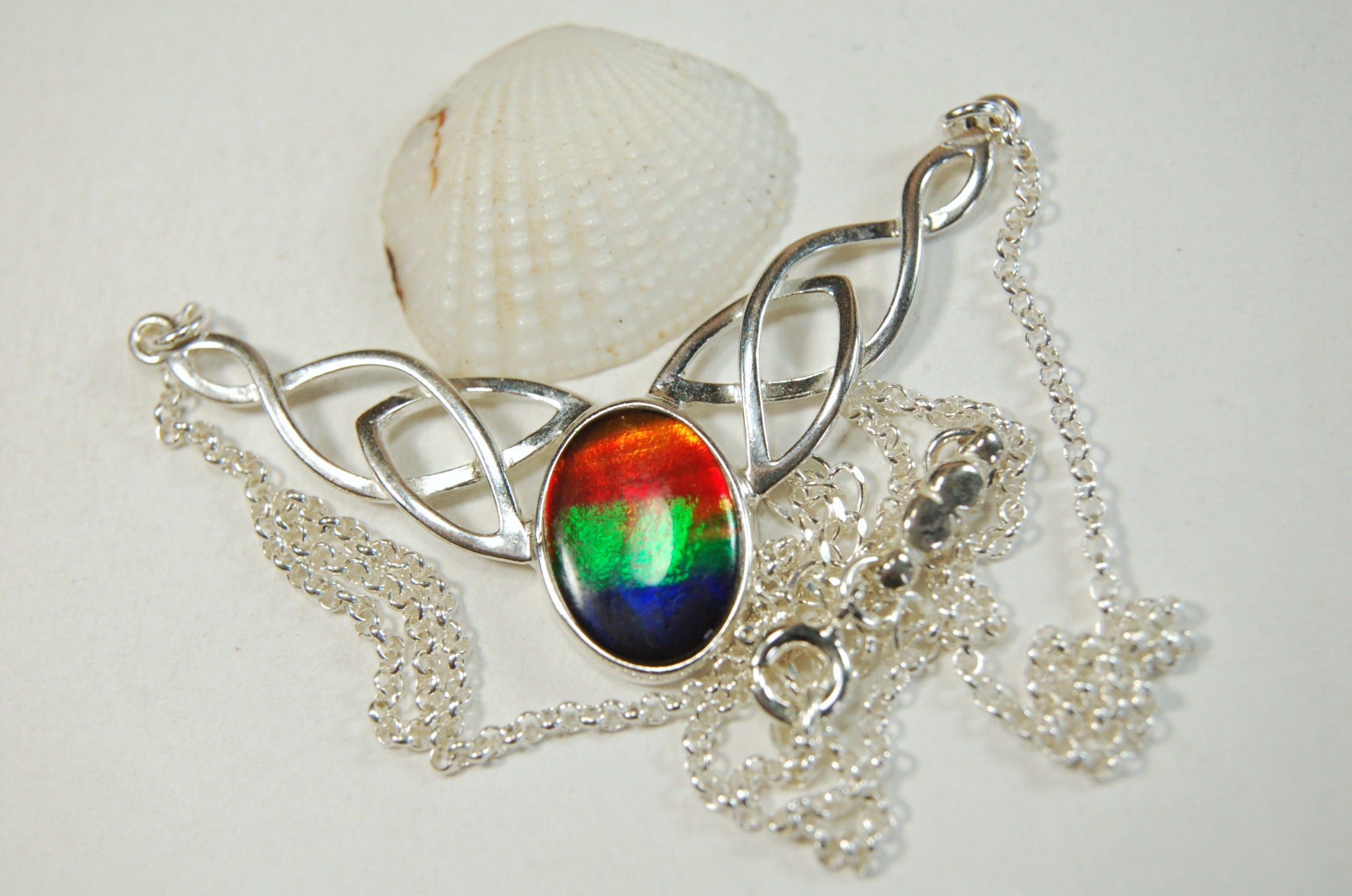 Ammolite Jewelry Necklace of the much admired Rainbow type.Four colors. Lovely Celtic setting with extender.#042513