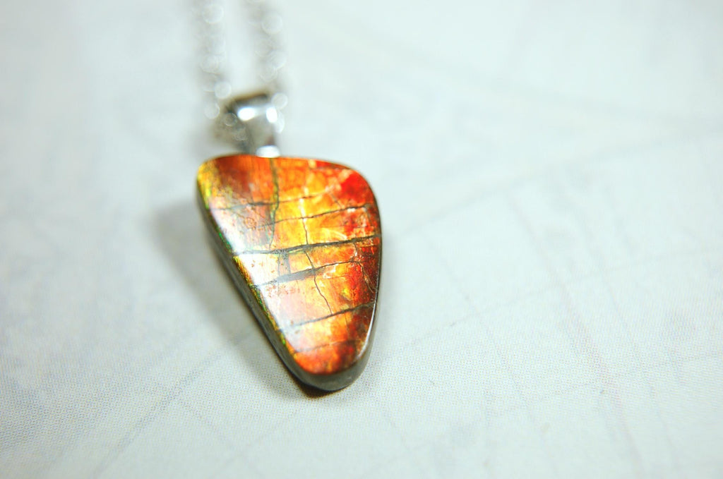 Ammolite Pendant with a gem of fire best appreciated in video.Amazing brilliance and hot colors.A big attention getter.022416
