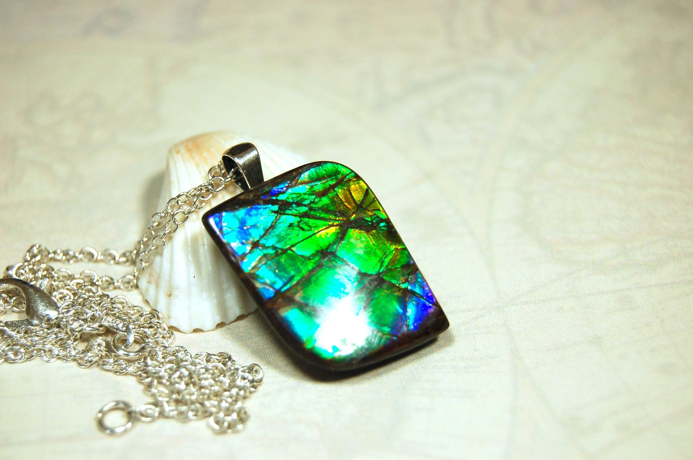 Ammolite Jewelry Pendant.Very high quality colors best seen in video.All natural cabochon gemstone from Alberta,Canada.031916