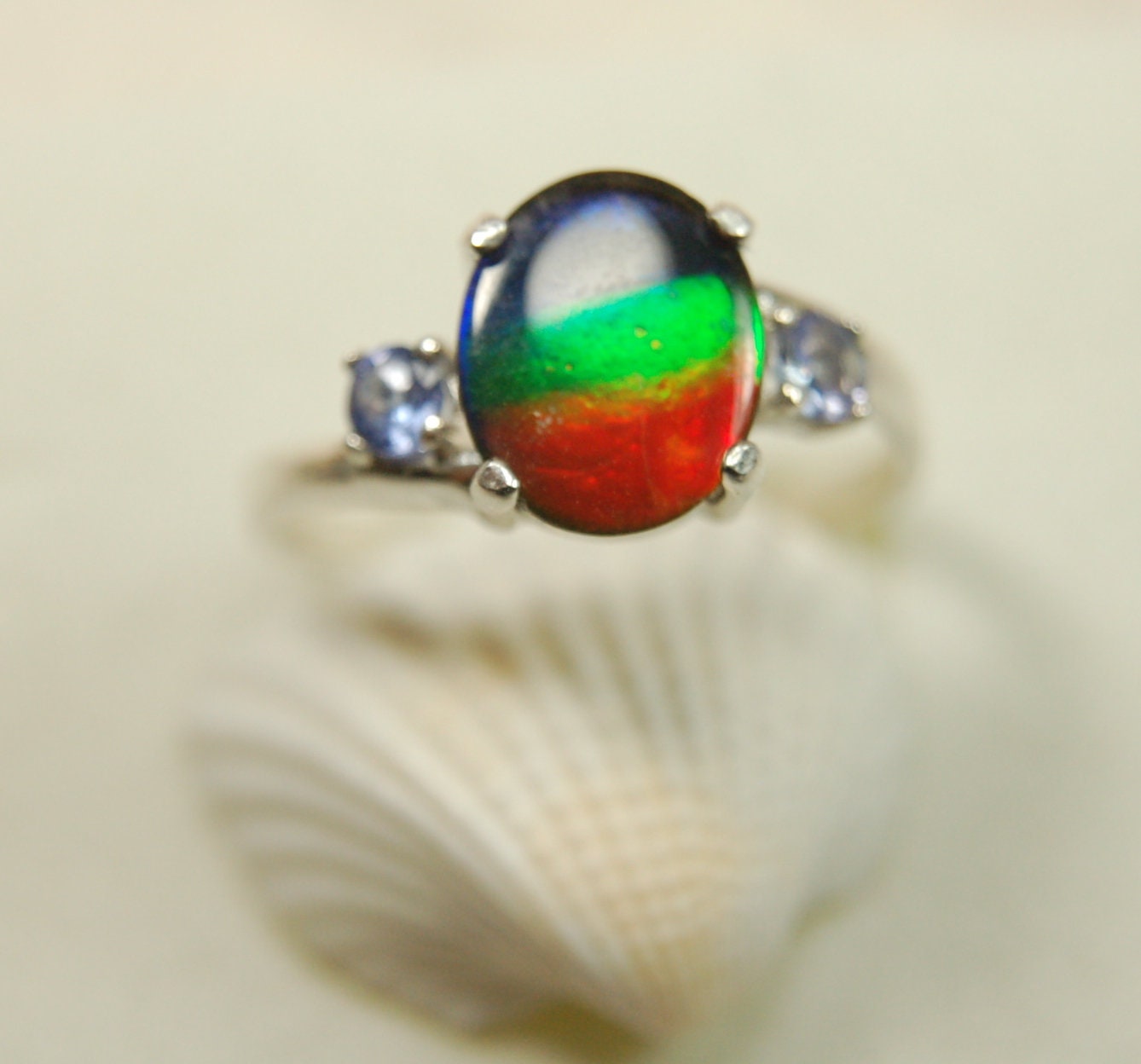 Ammolite Ring with brilliant colors and Tanzanite side stones.Size 7 #120223