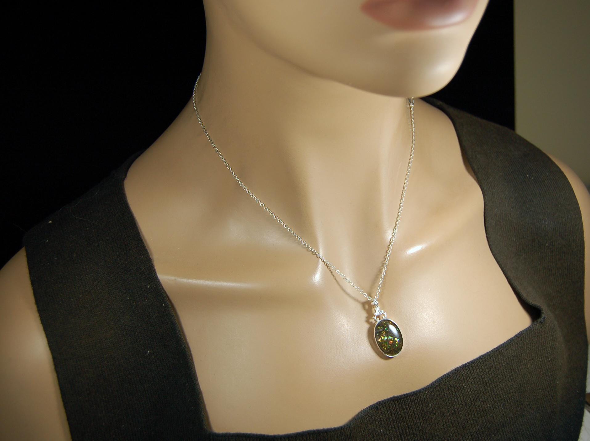 Ammolite Pendant.Rare sparks of color.Looks like a black Opal.One of a kind gem.Rare gift for her.Sterling Silver setting.022316