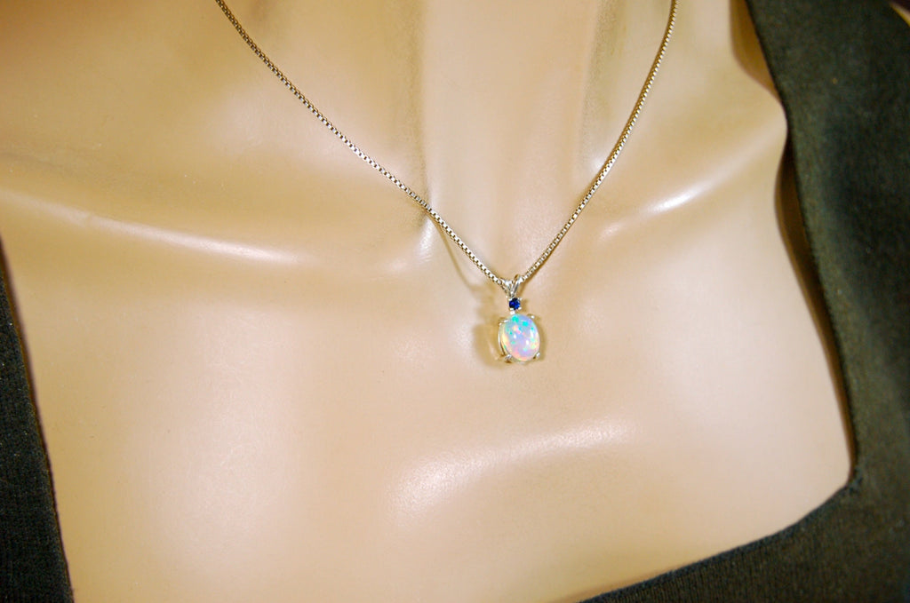 Natural opal pendant with blue sapphire.Good quality with many colors.The perfect gift.Must see video for true colors.042114