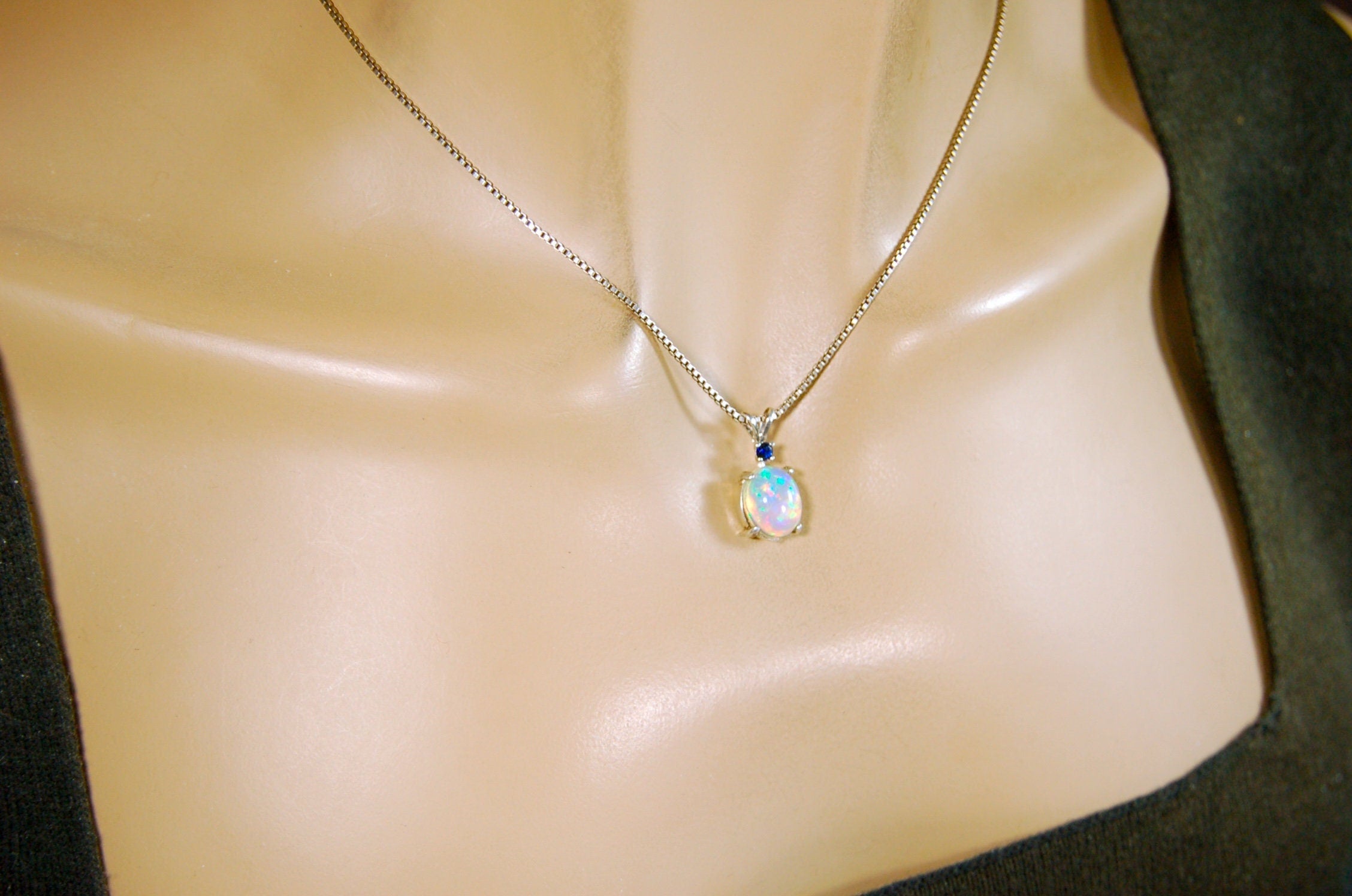 Natural opal pendant with blue sapphire.Good quality with many colors.The perfect gift.Must see video for true colors.042114