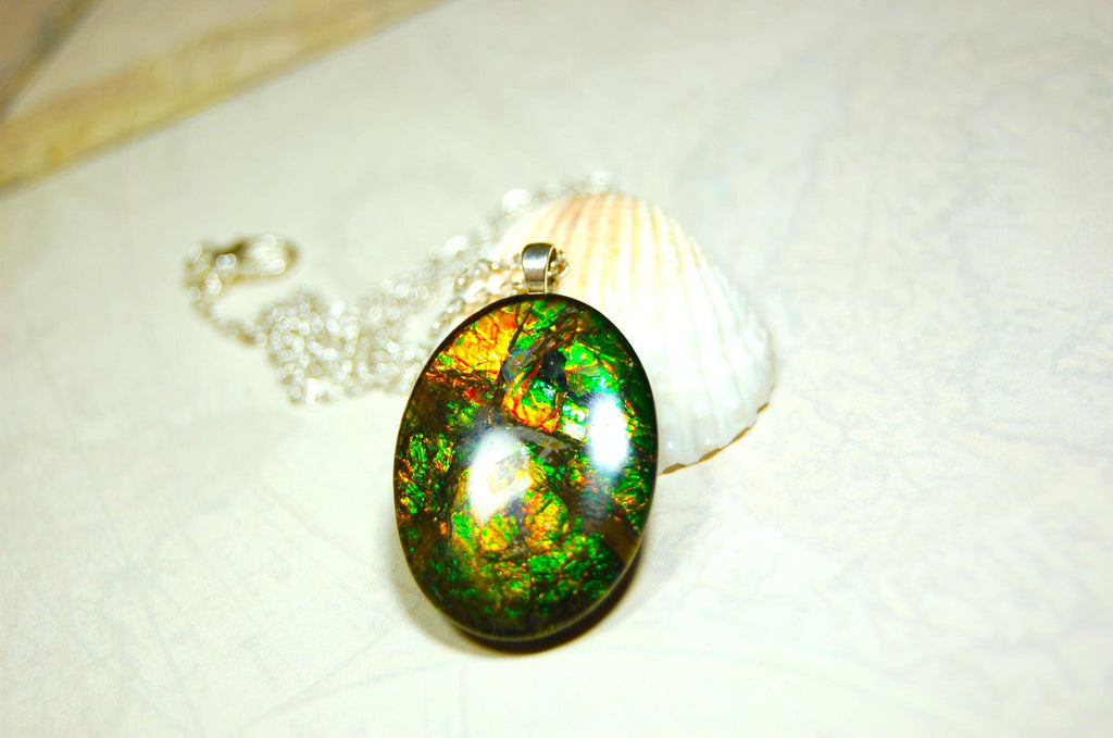 Ammolite cabochon pendant to upgrade your fashion accessory collection.Green and Copper colors.Sterling silver bail.Birthday gift? 032716