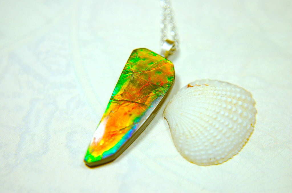 Ammolite necklace pendant.Natural rainbow cabochon of many bright colors.Strong color shifter.Video shows color best.030116