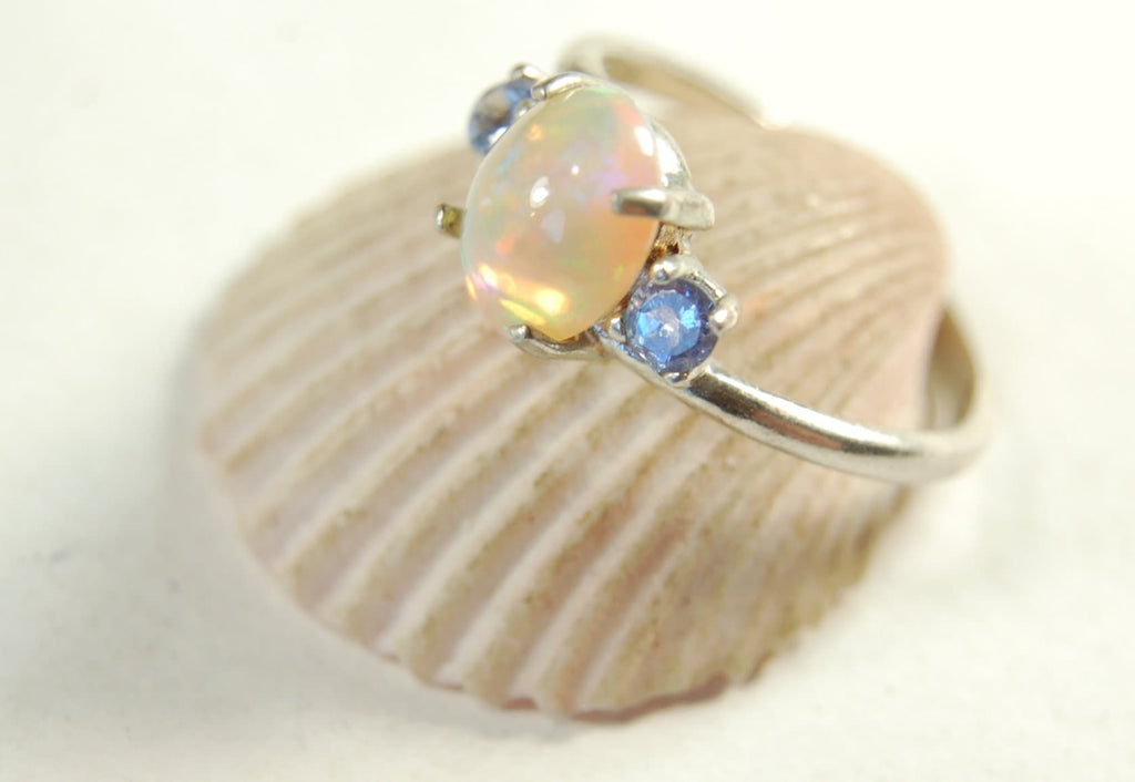 Opal ring.Solid African opal set in sterling silver with London Blue Topaz accent stones.Very feminine in size 6.