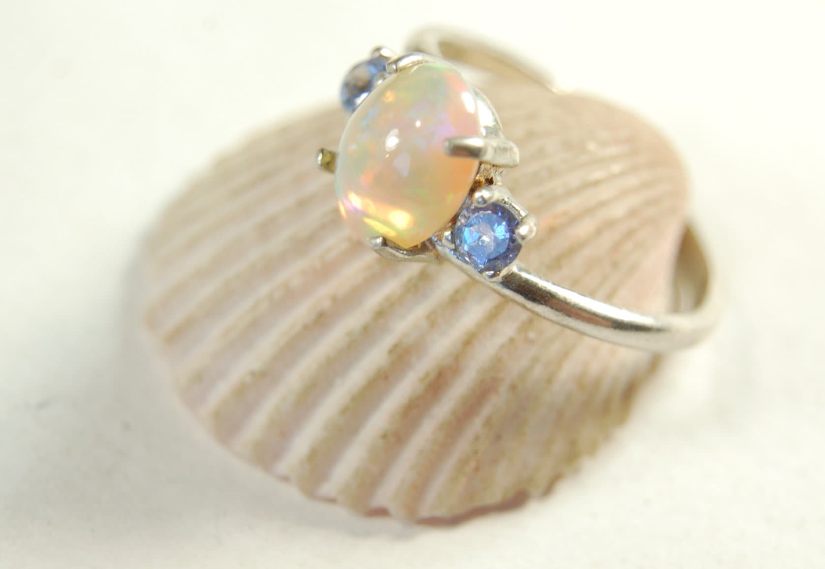 Opal ring.Solid African opal set in sterling silver with London Blue Topaz accent stones.Very feminine in size 6.