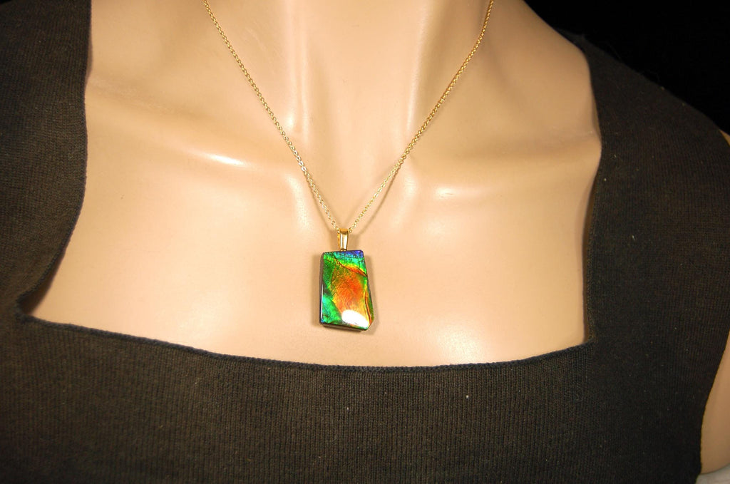 Ammolite pendant.Vivid colors in a high quality all natural cabochon with 14k gold filled bail.Fine fashion jewelry accessory 022516