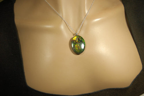 Ammolite cabochon pendant to upgrade your fashion accessory collection.Green and Copper colors.Sterling silver bail.Birthday gift? 032716
