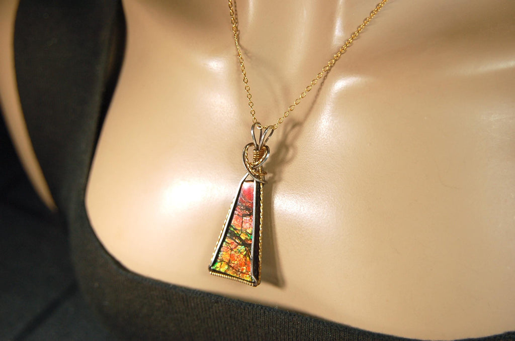 Unique Ammolite pendant set in Gold and sterling silver wire wrap.Natural cabochon in Canadian Maple fall colors.Must see video.082814