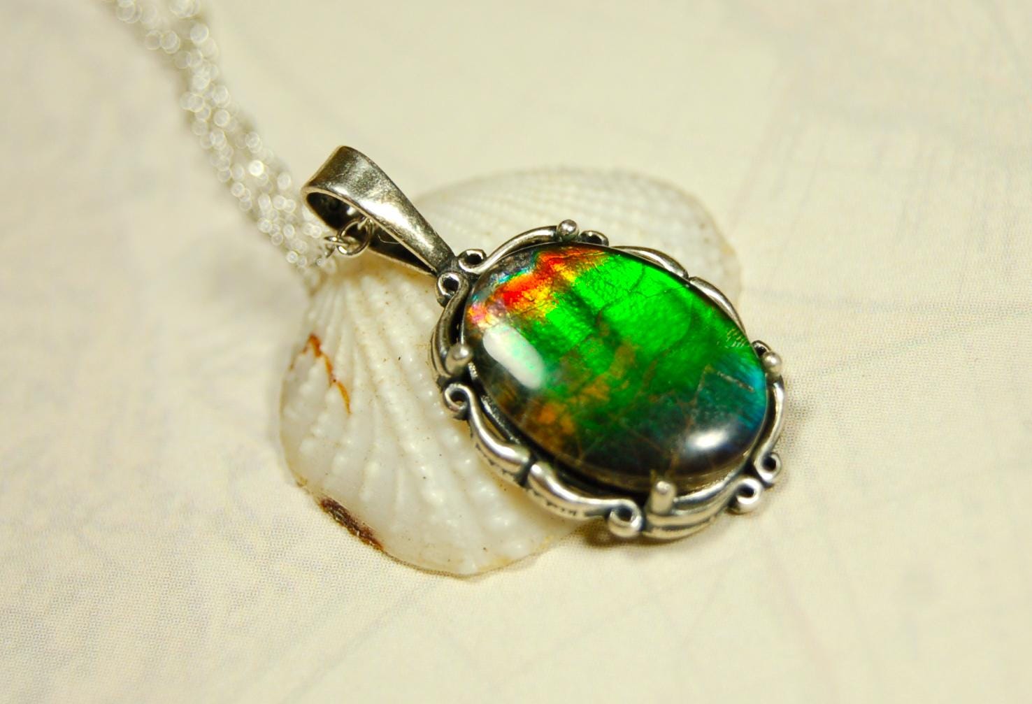 Ammolite Pendant elegantly set in sterling silver.Lovely greens and blues and flash of red.Fine anniversary gift idea for  wife.041916