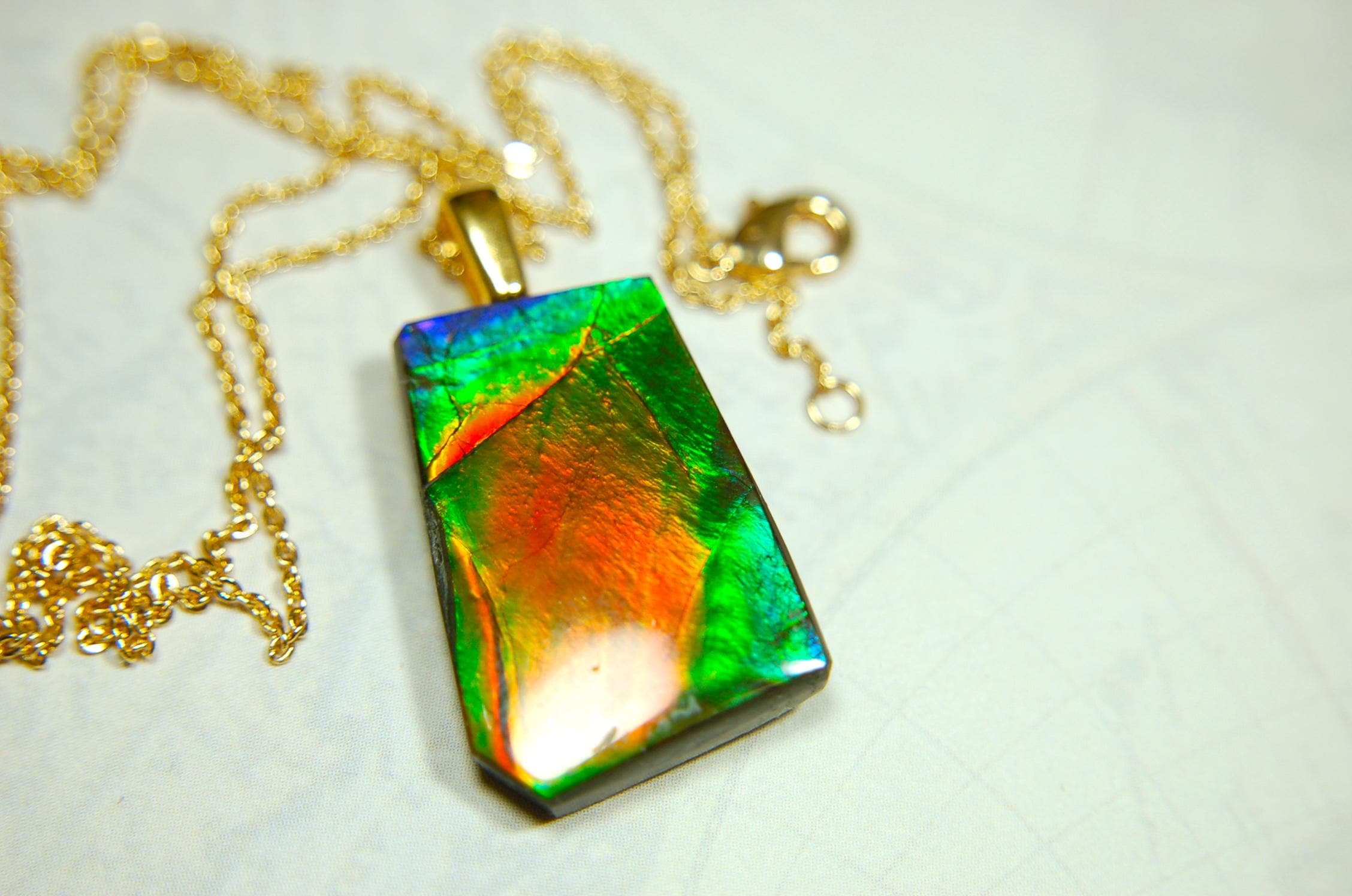 Ammolite pendant.Vivid colors in a high quality all natural cabochon with 14k gold filled bail.Fine fashion jewelry accessory 022516