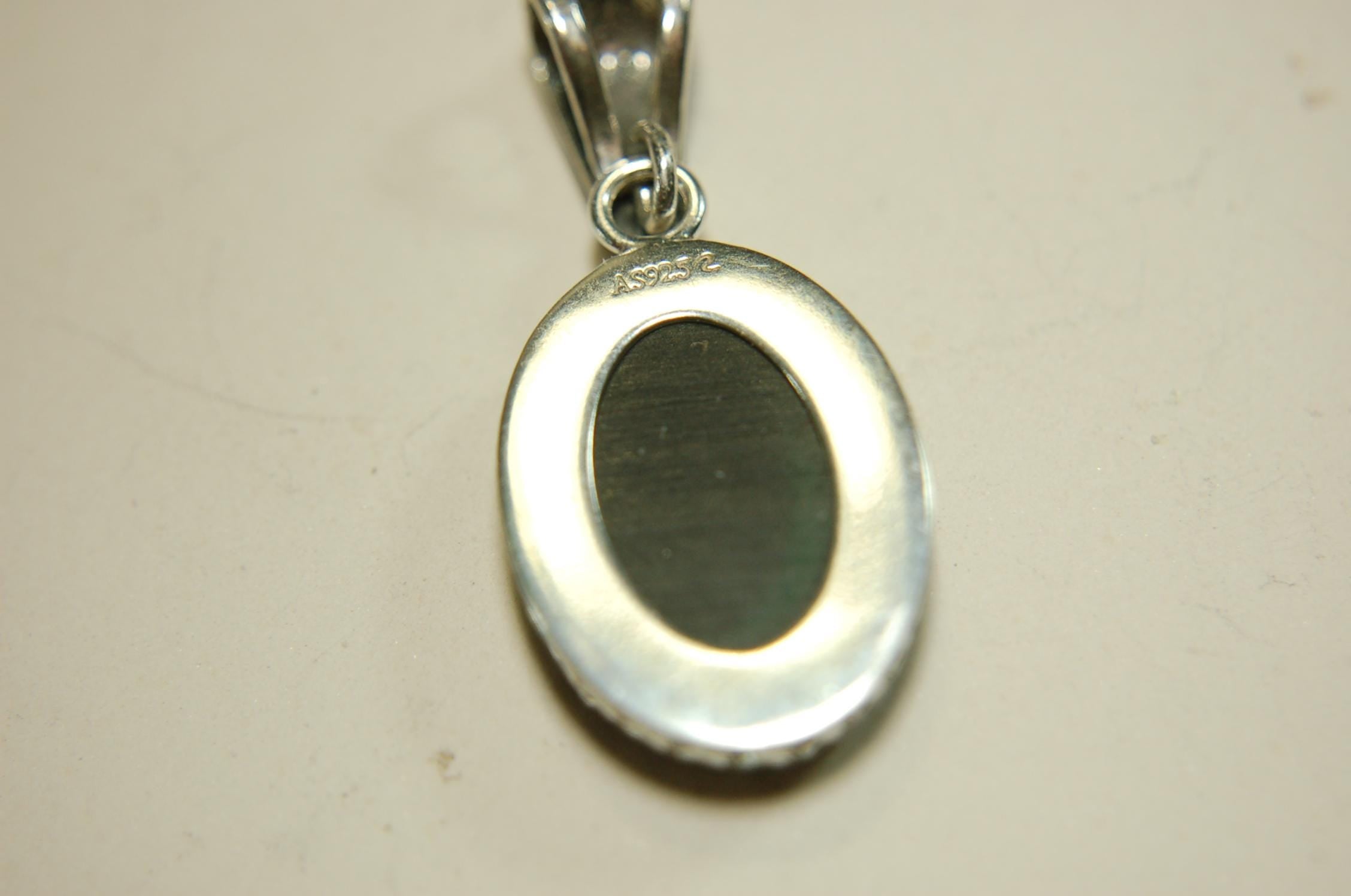 Ammolite Pendant Necklace.Resembles a fiery coal.Strong color shifter.Duty free under CUSMA rules.022115