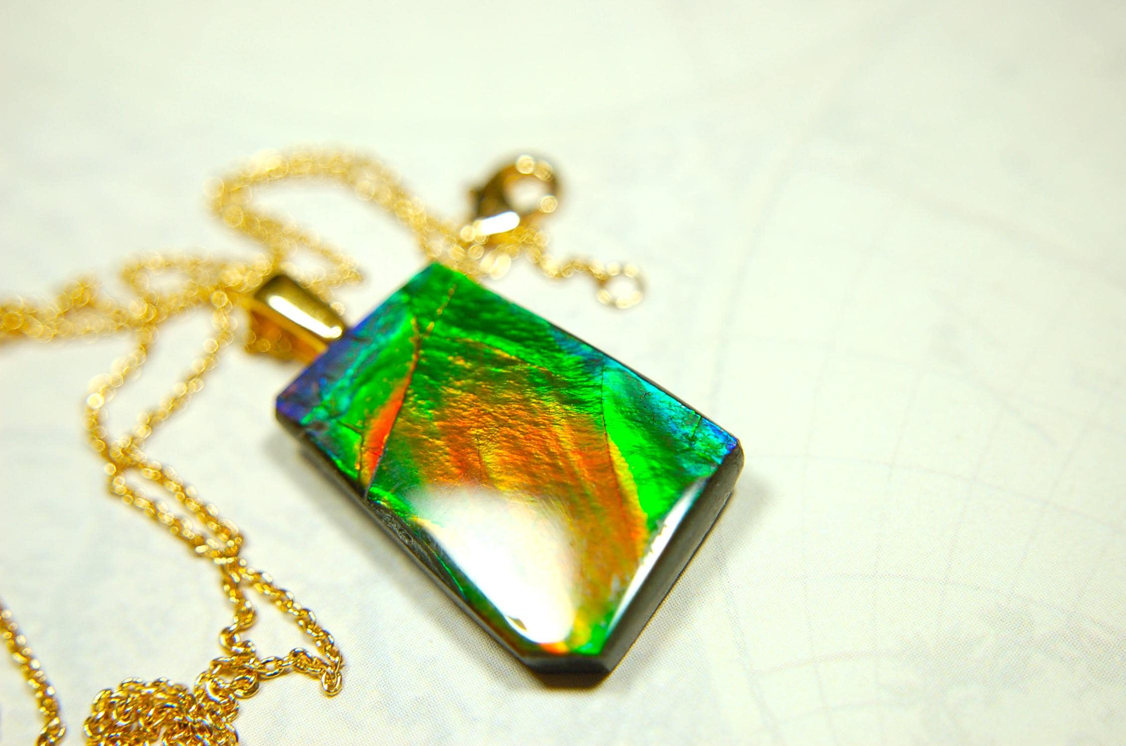 Ammolite pendant.Vivid colors in a high quality all natural cabochon with 14k gold filled bail.Fine fashion jewelry accessory 022516