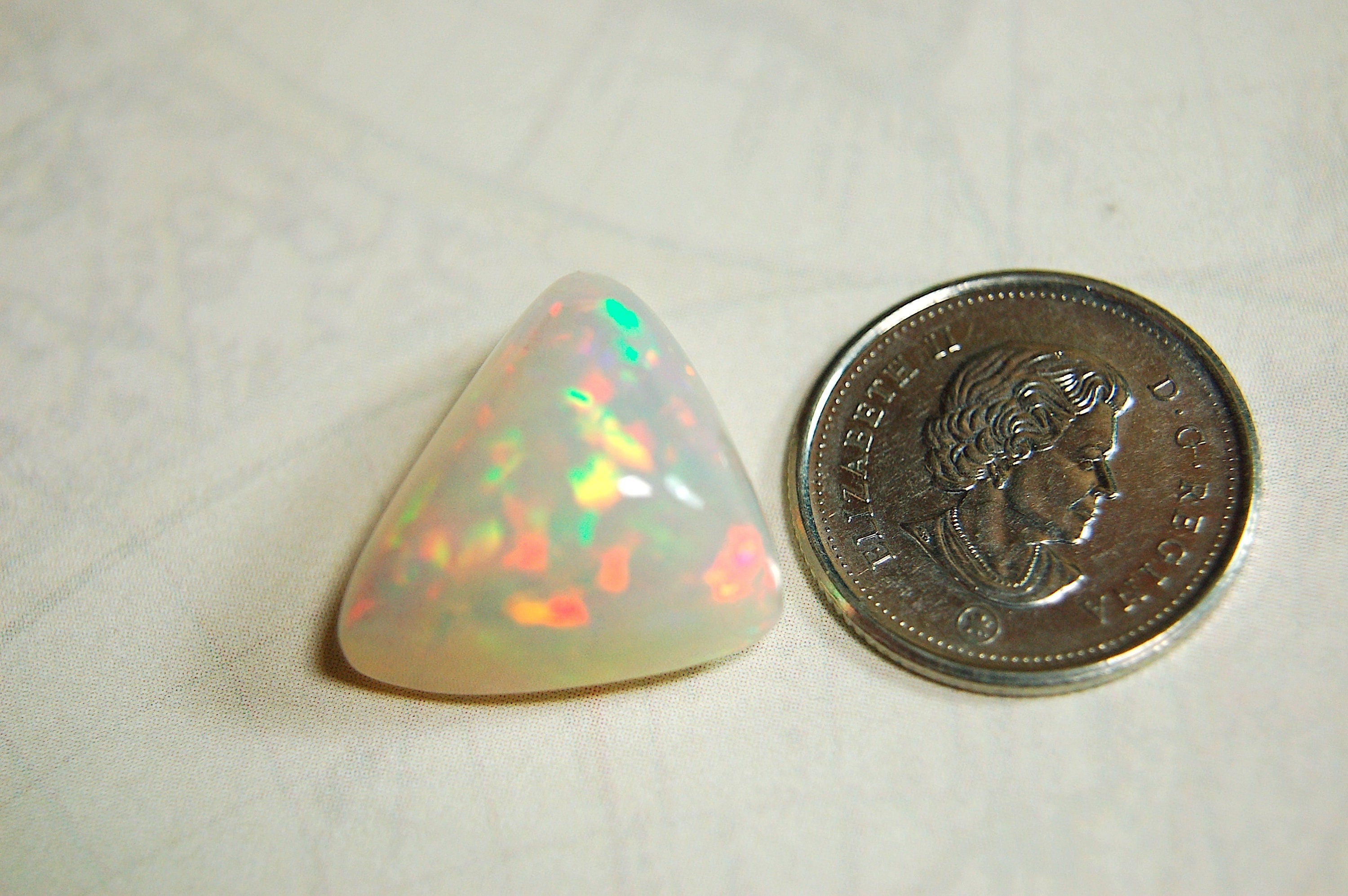Large genuine natural Opal Cabochon from Ethiopia.11 Carat beauty with many bright colors.Best viewed in video--better in hand.122813