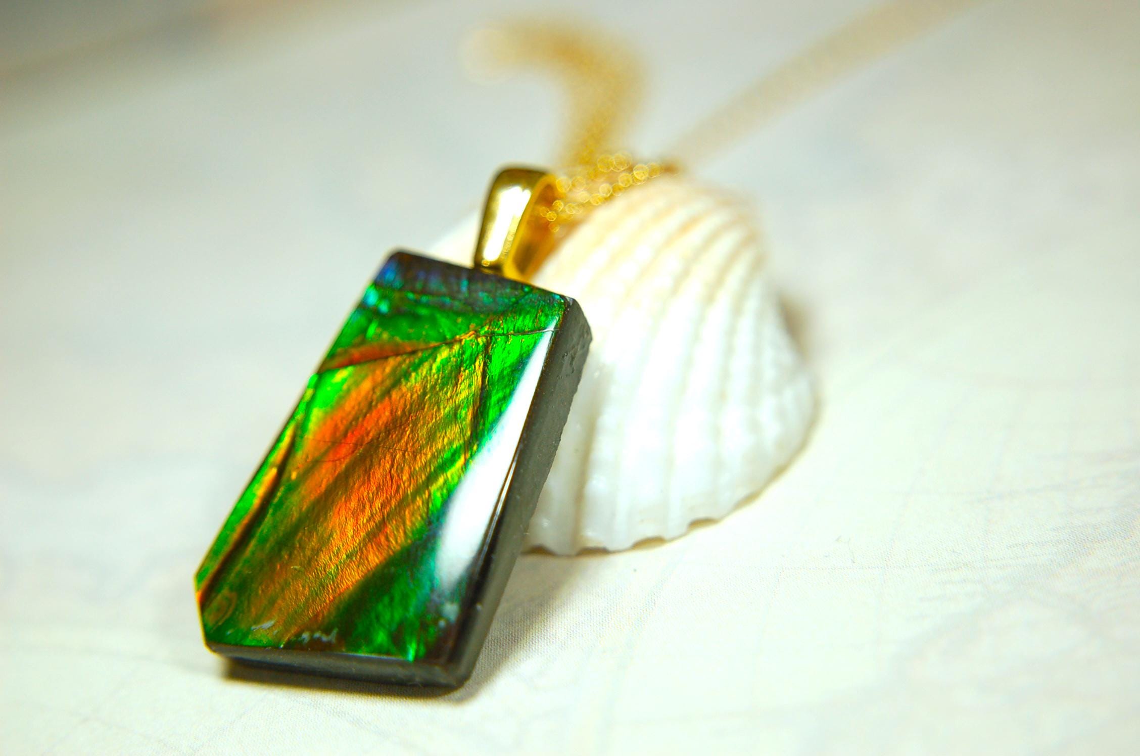 Ammolite pendant.Vivid colors in a high quality all natural cabochon with 14k gold filled bail.Fine fashion jewelry accessory 022516