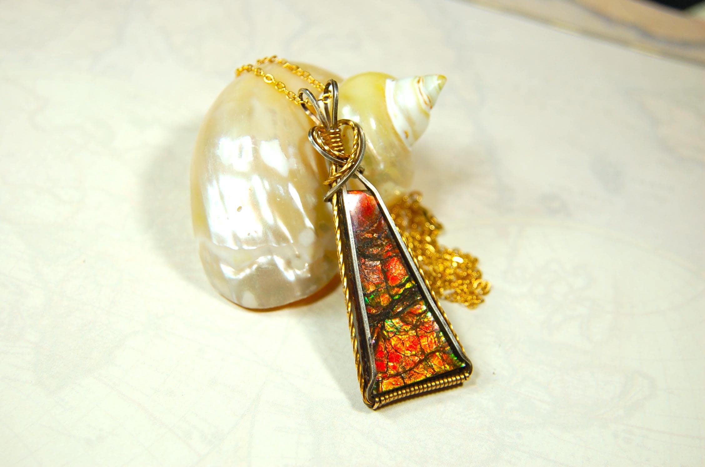 Unique Ammolite pendant set in Gold and sterling silver wire wrap.Natural cabochon in Canadian Maple fall colors.Must see video.082814