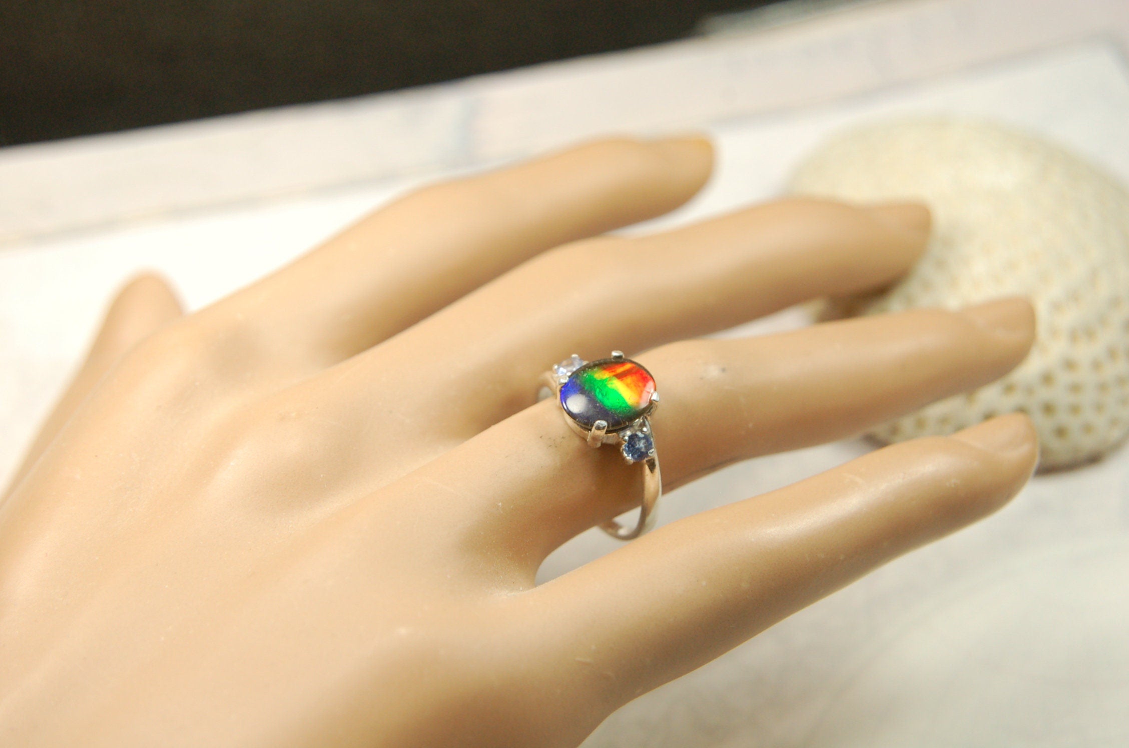 Ammolite Ring with brilliant colors and Tanzanite side stones.Size 7 #120223