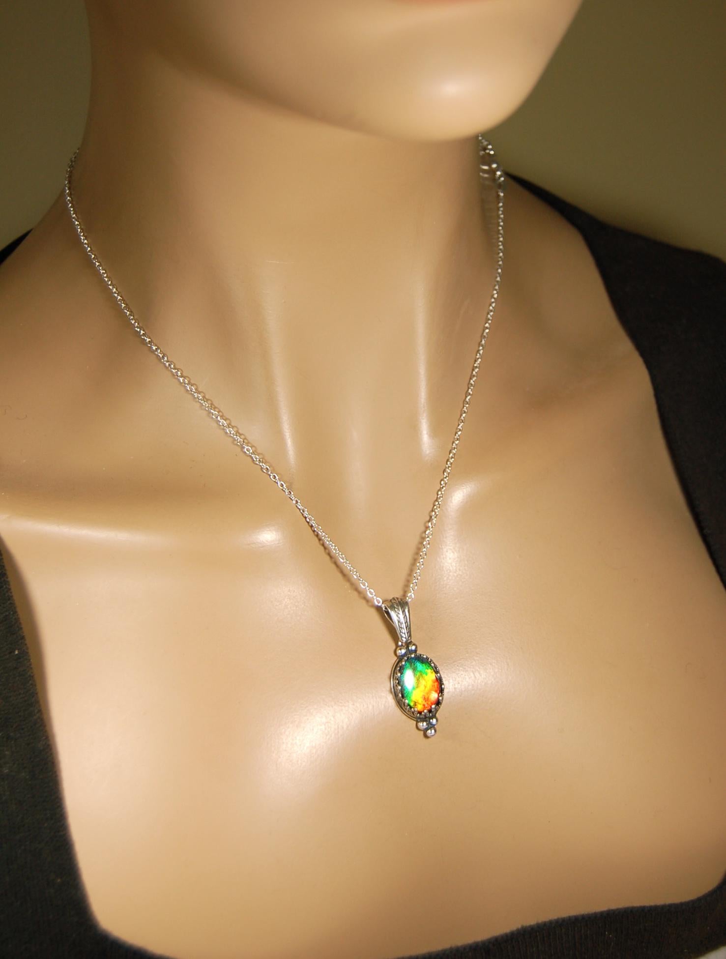 Ammolite Pendant elegantly set in sterling silver.Lovely greens and blues and flash of red.Fine anniversary gift idea for  wife.041916