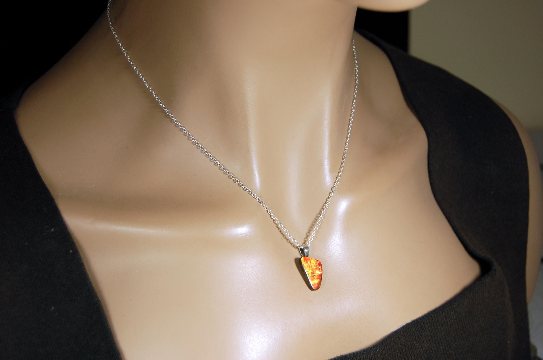 Ammolite Pendant with a gem of fire best appreciated in video.Amazing brilliance and hot colors.A big attention getter.022416