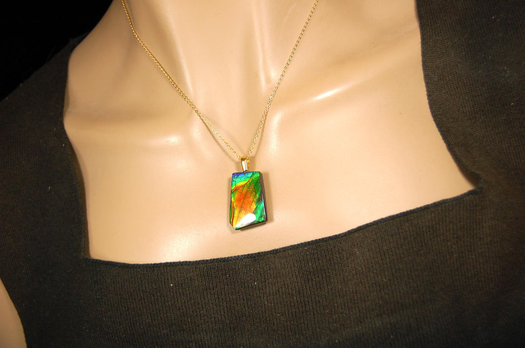 Ammolite pendant.Vivid colors in a high quality all natural cabochon with 14k gold filled bail.Fine fashion jewelry accessory 022516