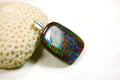Ammolite Pendant Necklace.RARE Natural gem with brilliant sparks of color on black background.--071815
