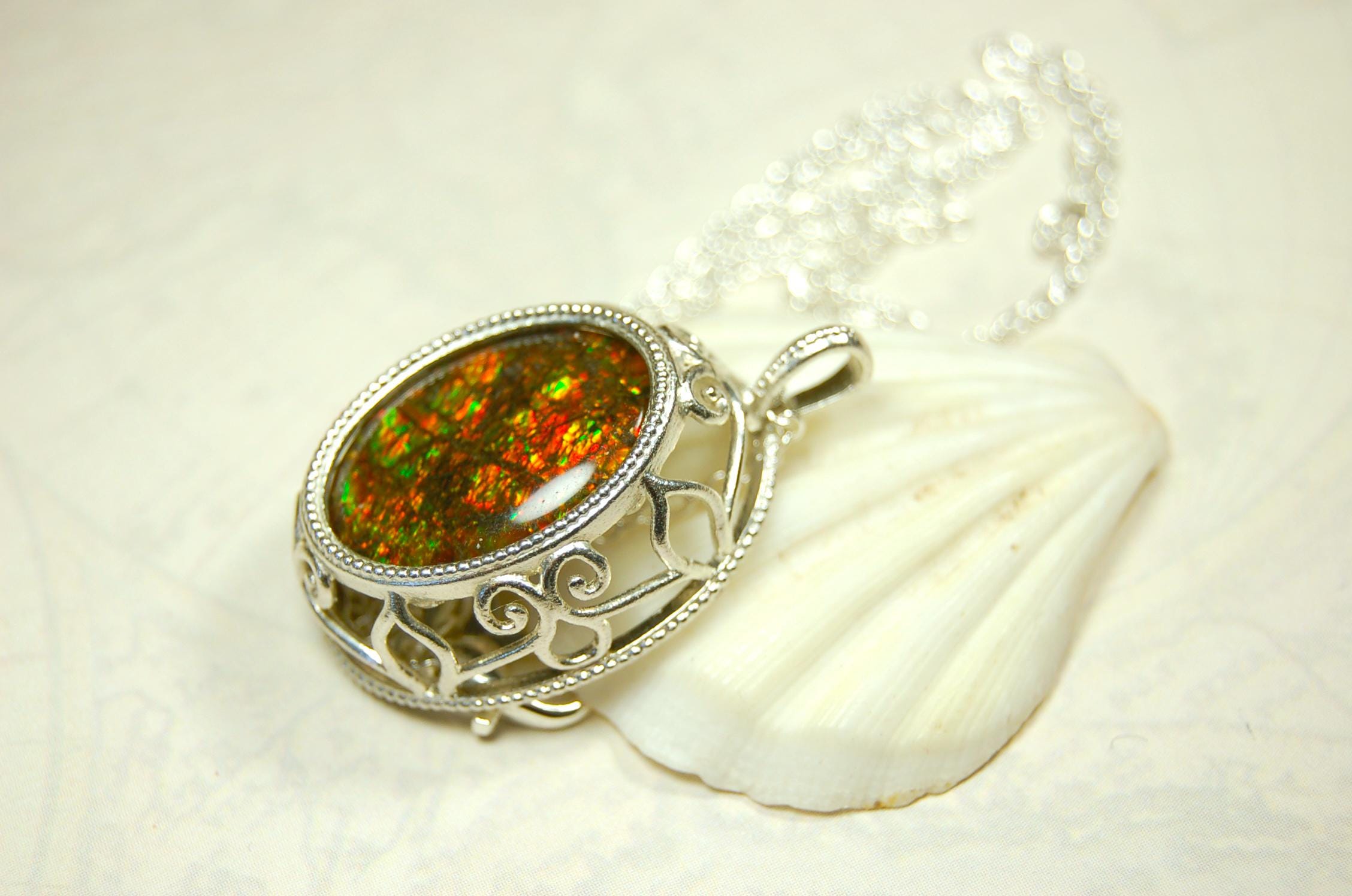 Unusual Ammolite pendant full of multicolor sparkles.A gift that will be treasured..032116