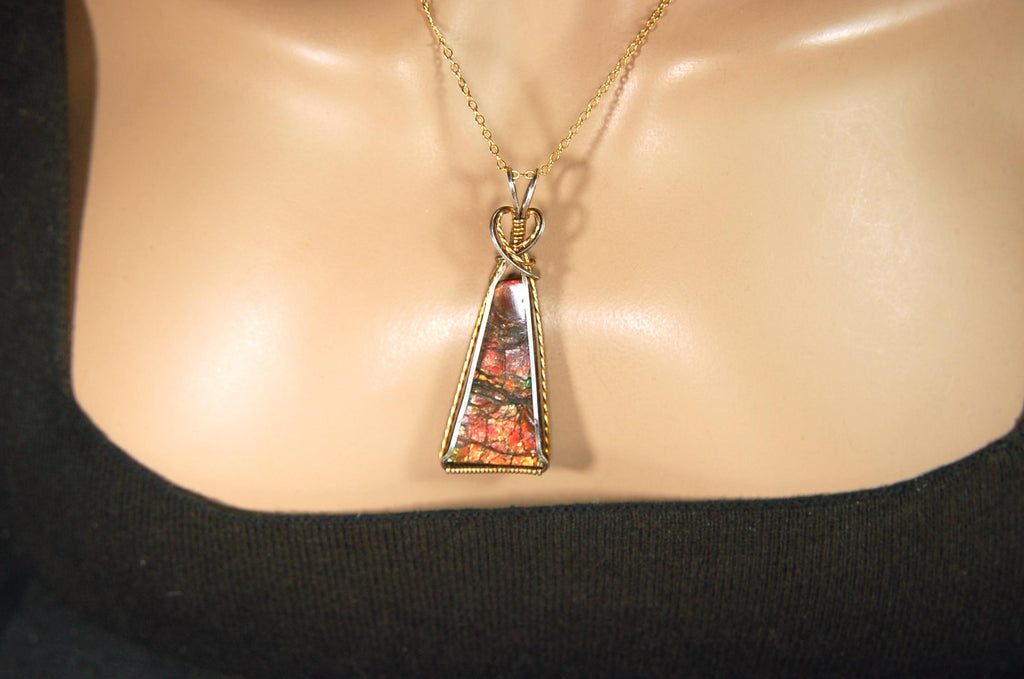 Unique Ammolite pendant set in Gold and sterling silver wire wrap.Natural cabochon in Canadian Maple fall colors.Must see video.082814