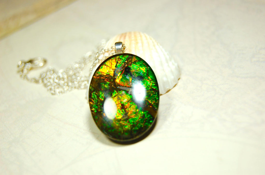 Ammolite cabochon pendant to upgrade your fashion accessory collection.Green and Copper colors.Sterling silver bail.Birthday gift? 032716