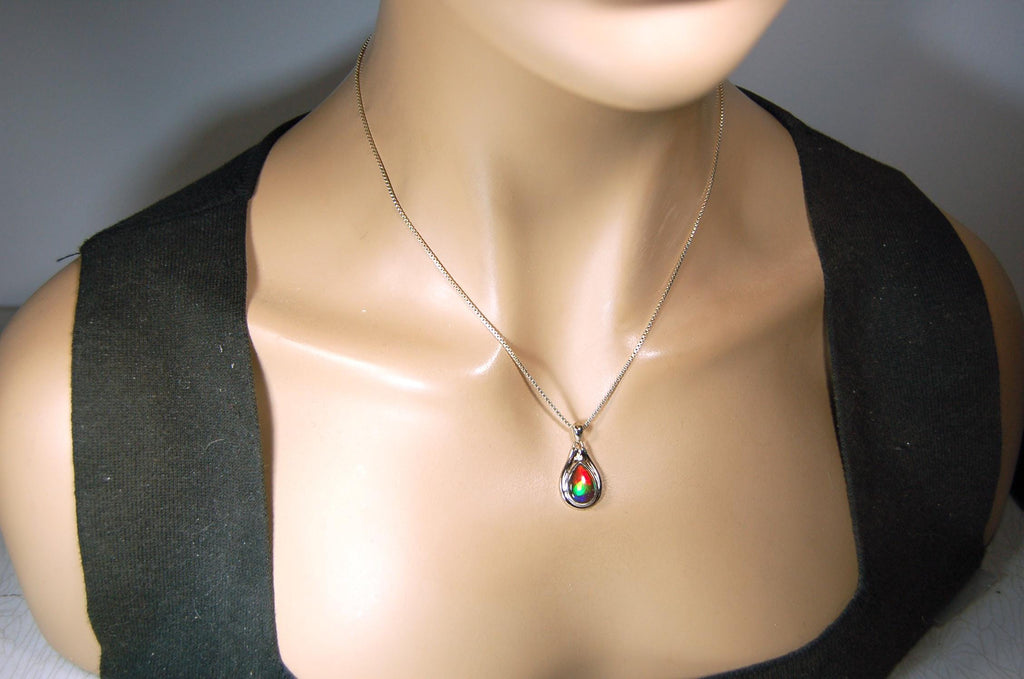 Buy Canadian Ammolite Pendant.Petite but very powerful colors.Perfect gift or gift for wife.Brilliant rainbow colors.Must see video.050429