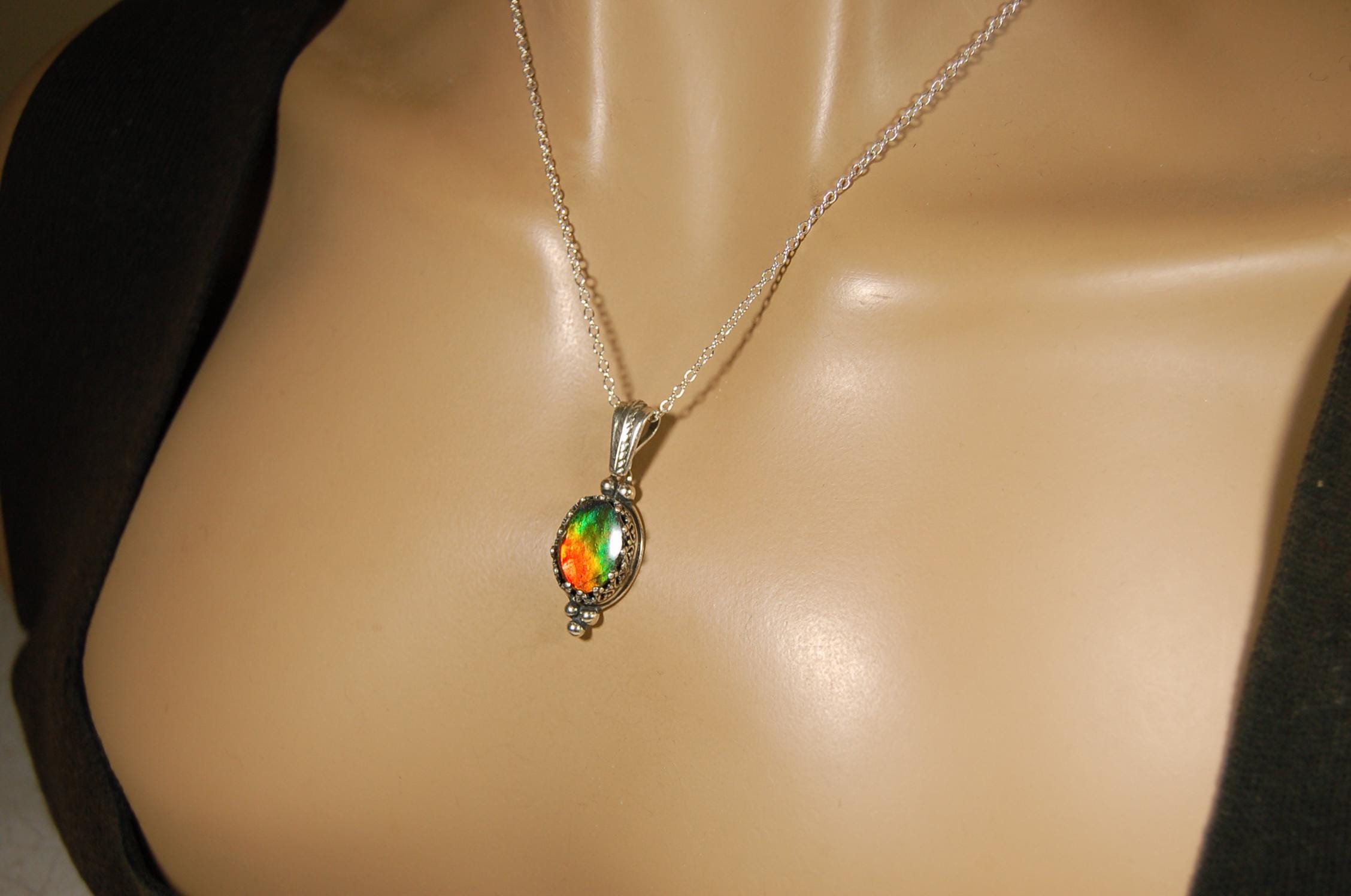Ammolite Pendant elegantly set in sterling silver.Lovely greens and blues and flash of red.Fine anniversary gift idea for  wife.041916