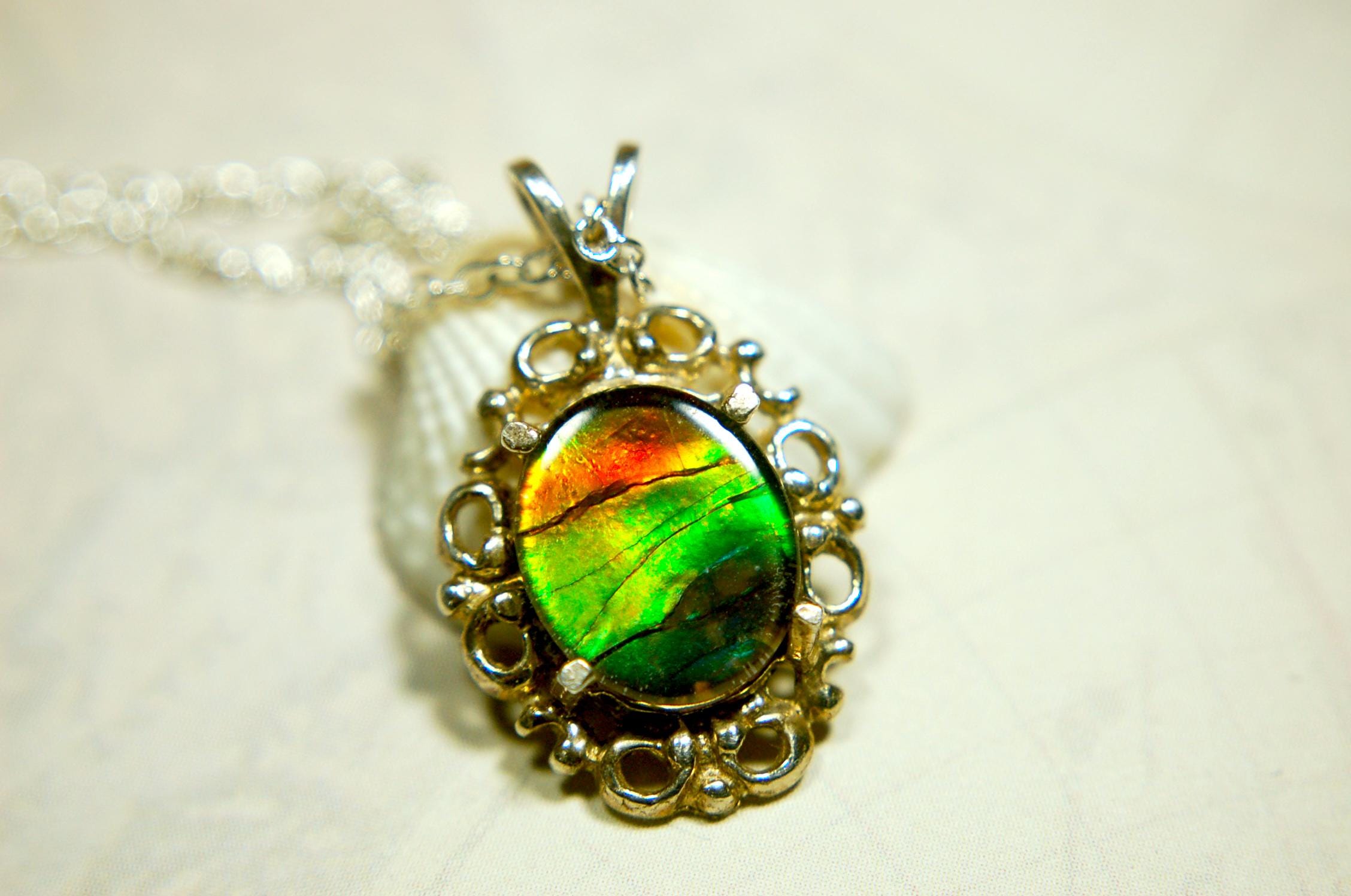 Ammolite Pendant from Alberta Canada.Genuine quality ammolite with warranty.The perfect gift.010926