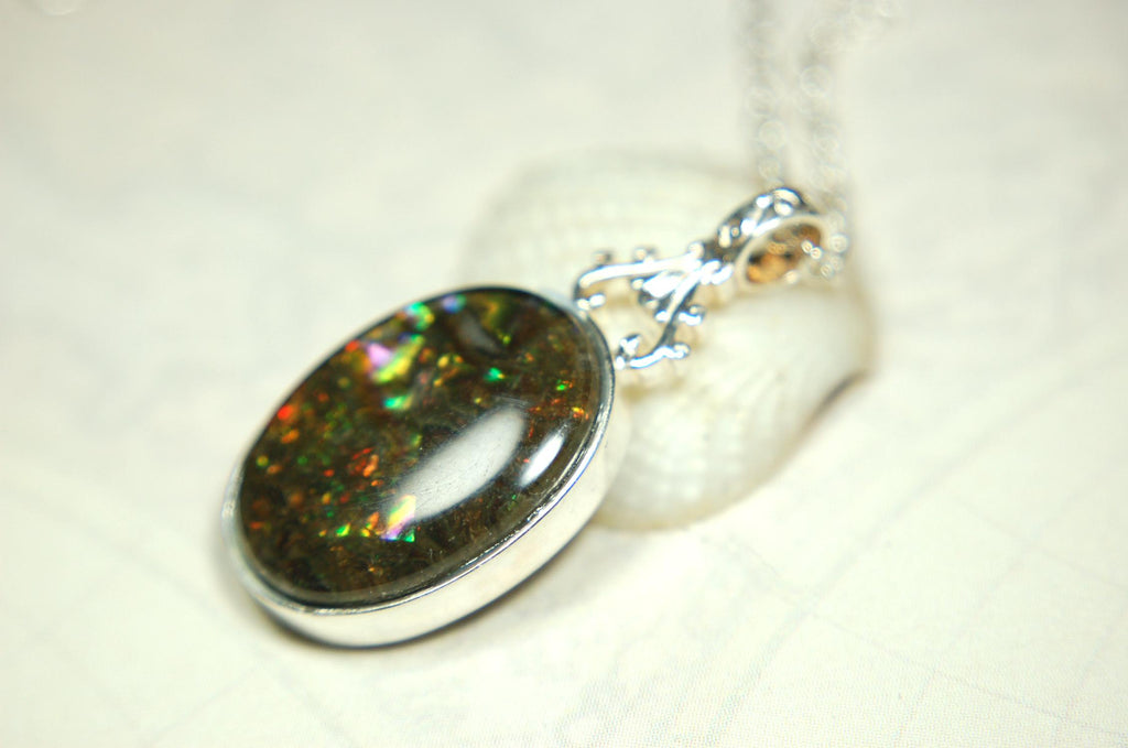 Ammolite Pendant.Rare sparks of color.Looks like a black Opal.One of a kind gem.Rare gift for her.Sterling Silver setting.022316
