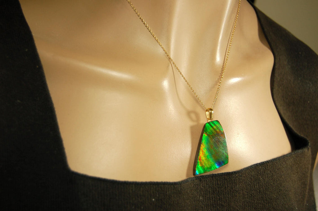 Ammolite Pendant.Natural Cabochon with strong color changing abilities.14kGF Gold bail.Elevate your style.030716