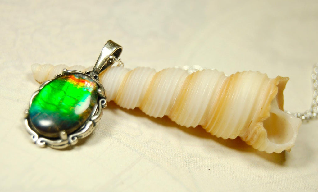 Ammolite Pendant elegantly set in sterling silver.Lovely greens and blues and flash of red.Fine anniversary gift idea for  wife.041916