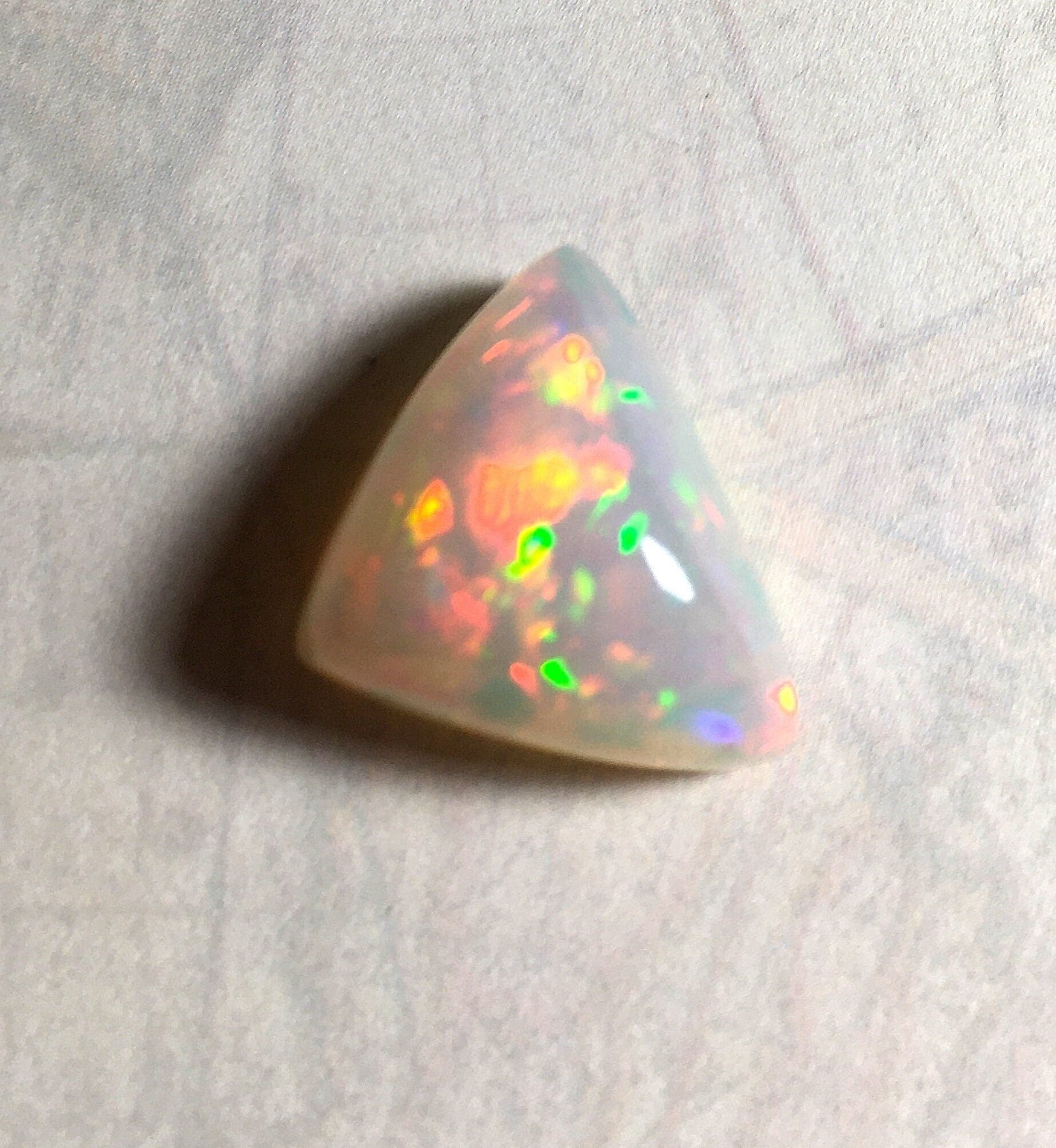 Large genuine natural Opal Cabochon from Ethiopia.11 Carat beauty with many bright colors.Best viewed in video--better in hand.122813