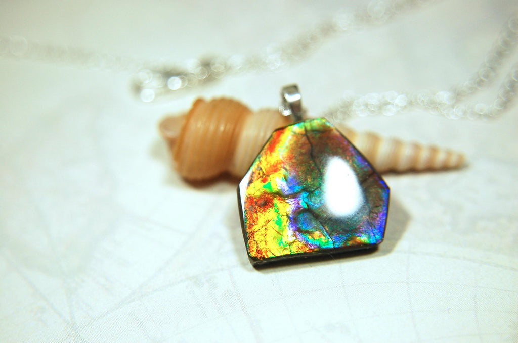 Ammolite pendant.RARE colors.Best seen in video.All natural cabochon from Alberta Canada.Thoughtful gift for her.022716