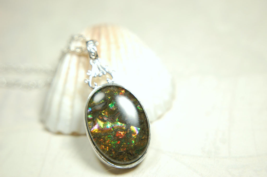Ammolite Pendant.Rare sparks of color.Looks like a black Opal.One of a kind gem.Rare gift for her.Sterling Silver setting.022316
