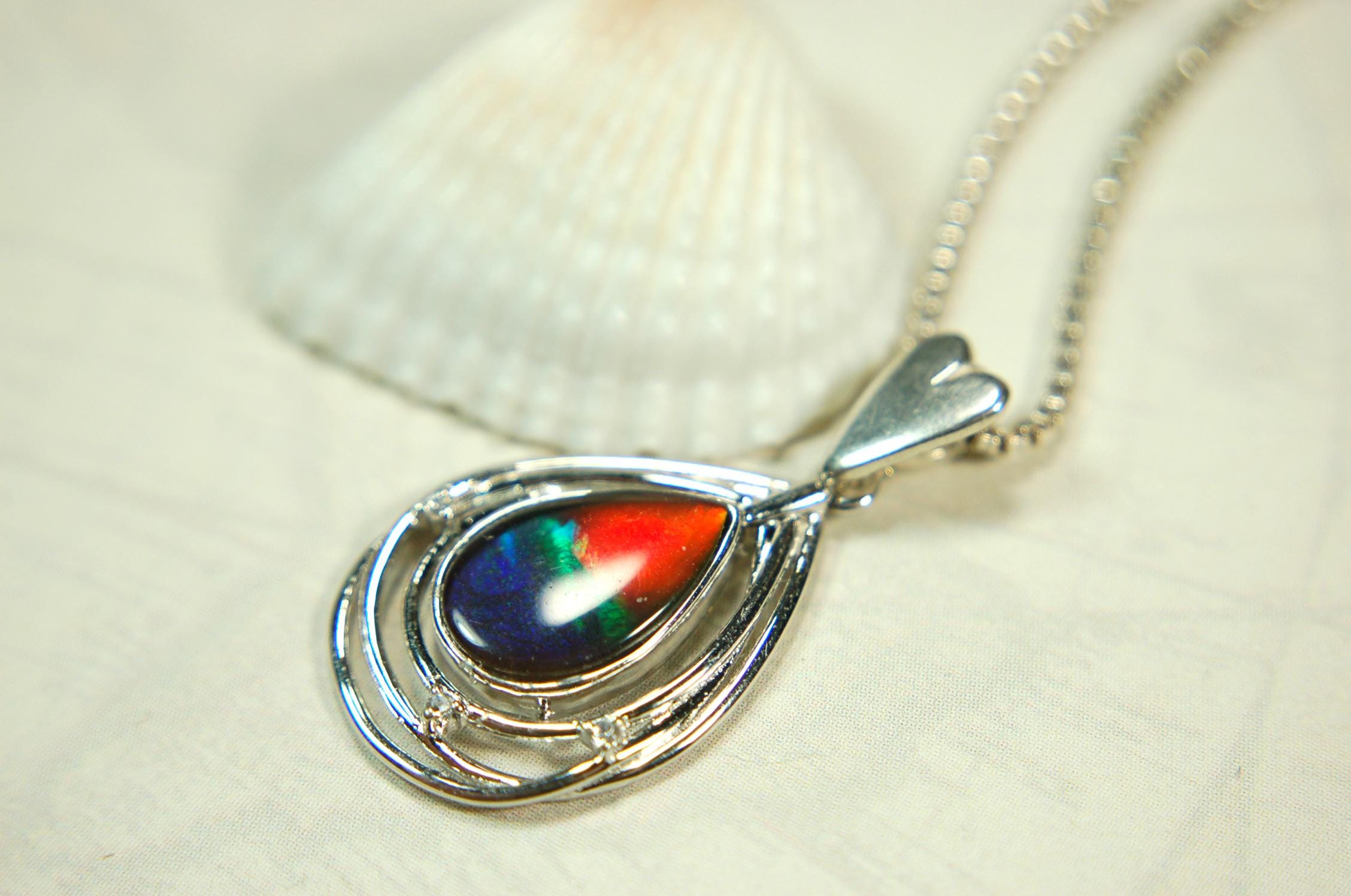 Eye-Catching Ammolite Pendant gift for Mothers Day she will treasure.Genuine Ammolite mined, finished and shipped from Canada 032015