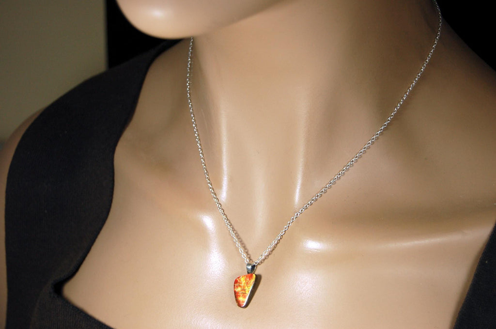 Ammolite Pendant with a gem of fire best appreciated in video.Amazing brilliance and hot colors.A big attention getter.022416