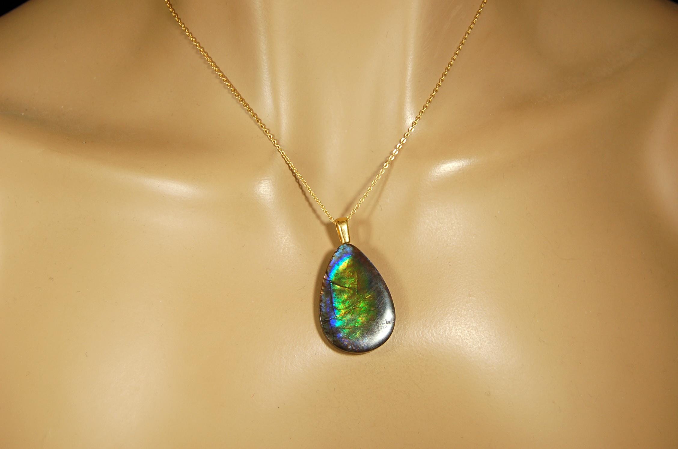 Ammolite Pendant with peacock colors.Natural cabochon gemstone mined and shipped from Canada.Gift of unique jewelry..020926