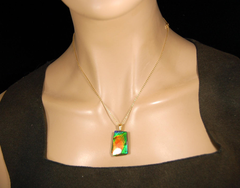 Ammolite pendant.Vivid colors in a high quality all natural cabochon with 14k gold filled bail.Fine fashion jewelry accessory 022516